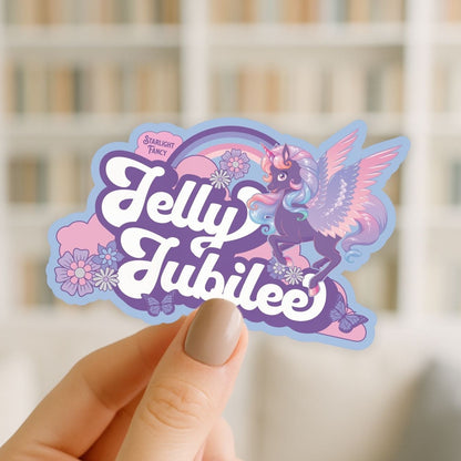 Sticker with 'Jelly Jubilee' design held by a hand against a blurred background