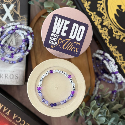 Bracelet with 'We Do Not Eat Our Allies' message on a decorative background