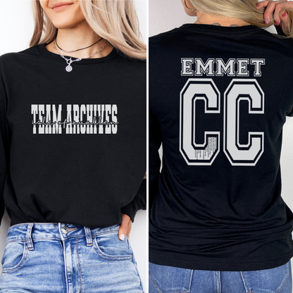 Black sweatshirt with 'Team Archives' on the front and 'EMMET CC' on the back, worn by a person.