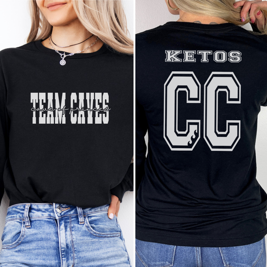 Black sweatshirt with 'Team Caves' text on front and 'KETOS CC' text on back, worn by a person.