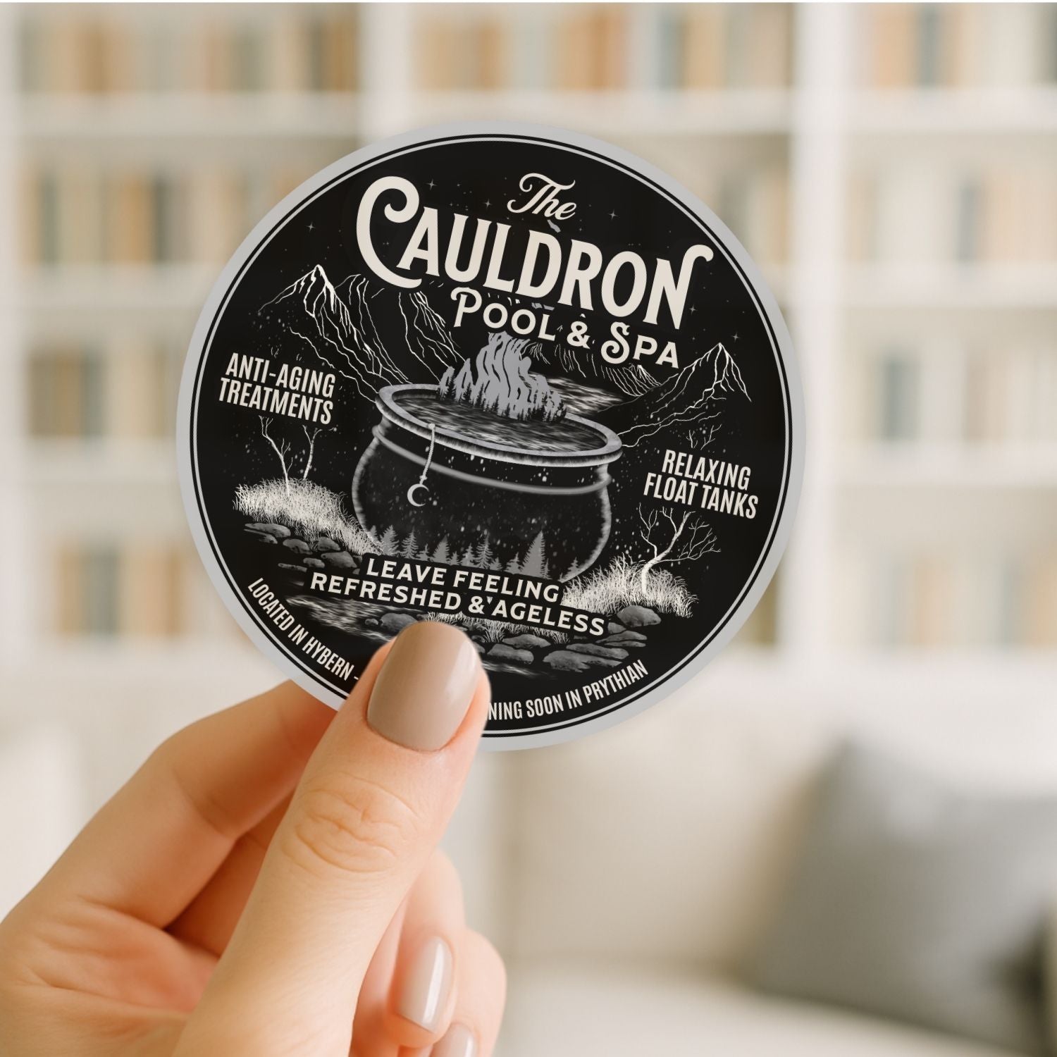 Hand holding a circular product packaging with 'The Cauldron Pool & Spa' branding.