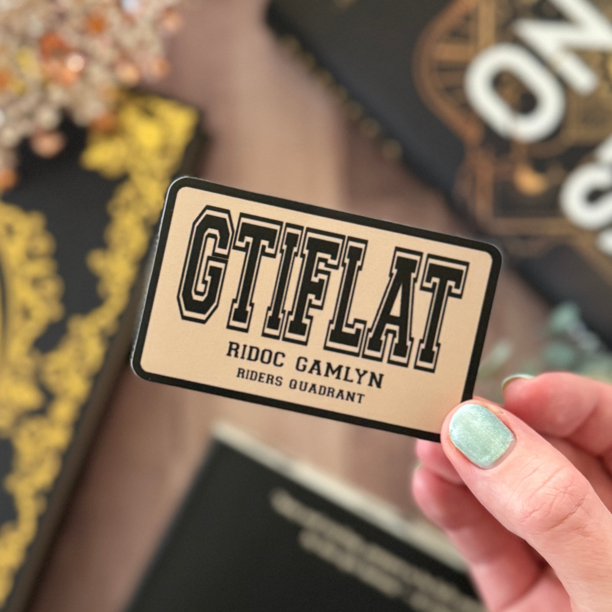Hand holding a 'GTIFLAT' card with decorative background